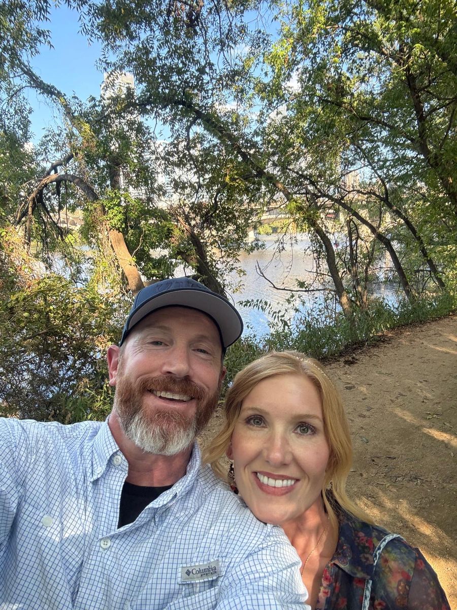 Tabitha and Kevin Lovell on a tree-lined lakeside trail in Austin, Texas